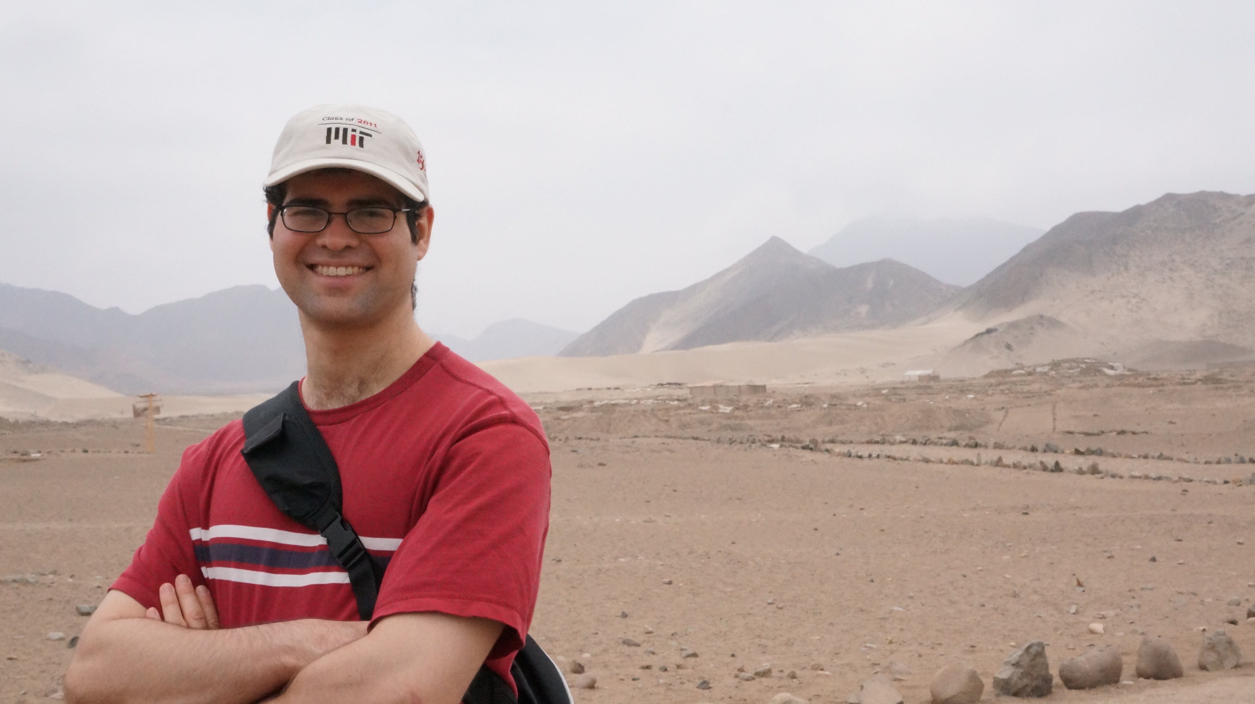 Jesse standing in front of a desert landscape at Caral